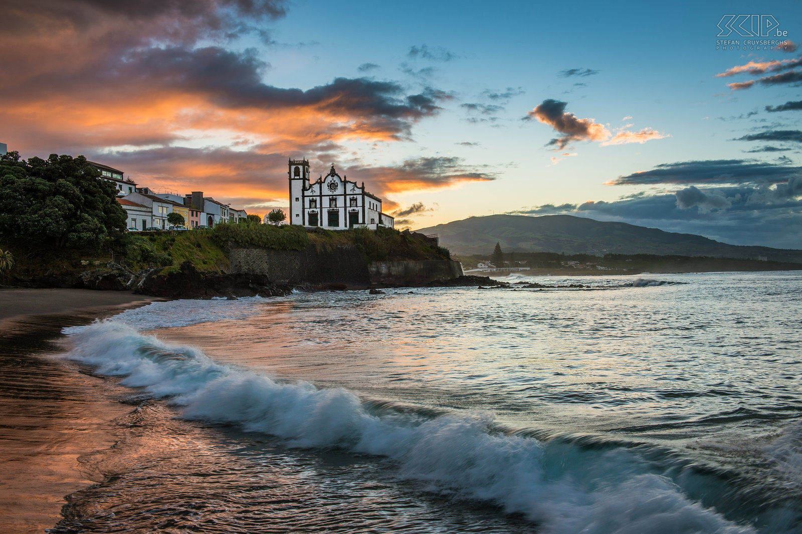 Sunrise Sao Roque A wonderful sunrise at the black sandy beach of São Roque with the church in the background. São Roque is a civil parish in the municipality of Ponta Delgada, the administrative capital of the Azores. The beautiful church (ingreja) of São Roque is perched above the ocean and separates two beaches. Stefan Cruysberghs